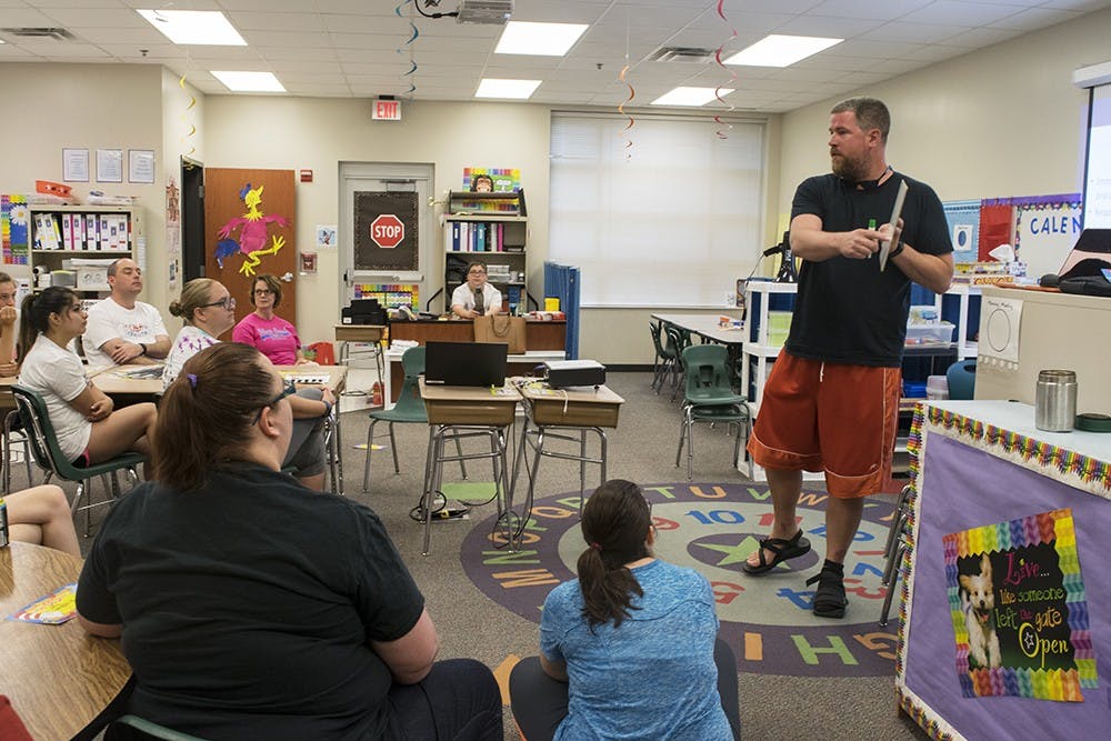 Mark Howard, a teacher at Clear Creek Elementary school, gives a short lecture to Camp Connections staff on how to use token economies as external reinforcement. Token economies reward students for positive behavior and allow them to visualize how close they are to meeting a goal.