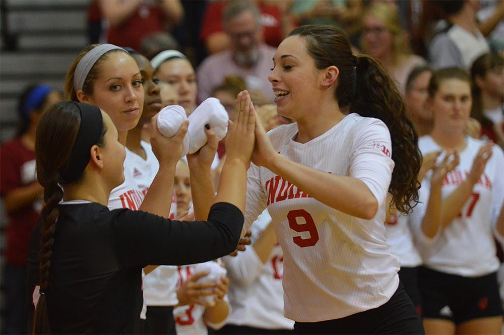 Megan Tallman gives high fives to other teammates as they are announced before the game against Purdue on Oct. 7. The Hoosiers lost 0-3