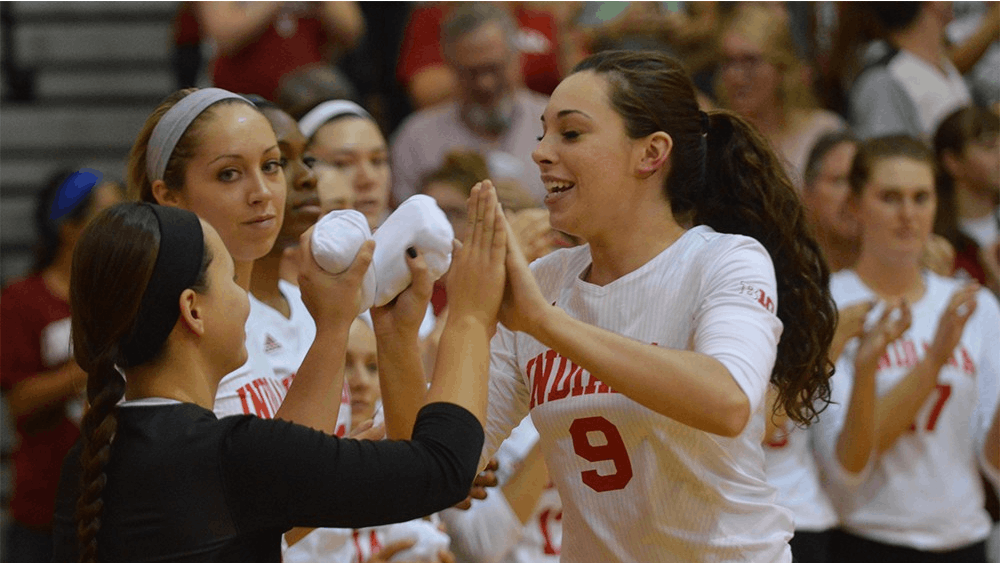 Megan Tallman gives high fives to other teammates as they are announced before the game against Purdue on Oct. 7. The Hoosiers lost 0-3