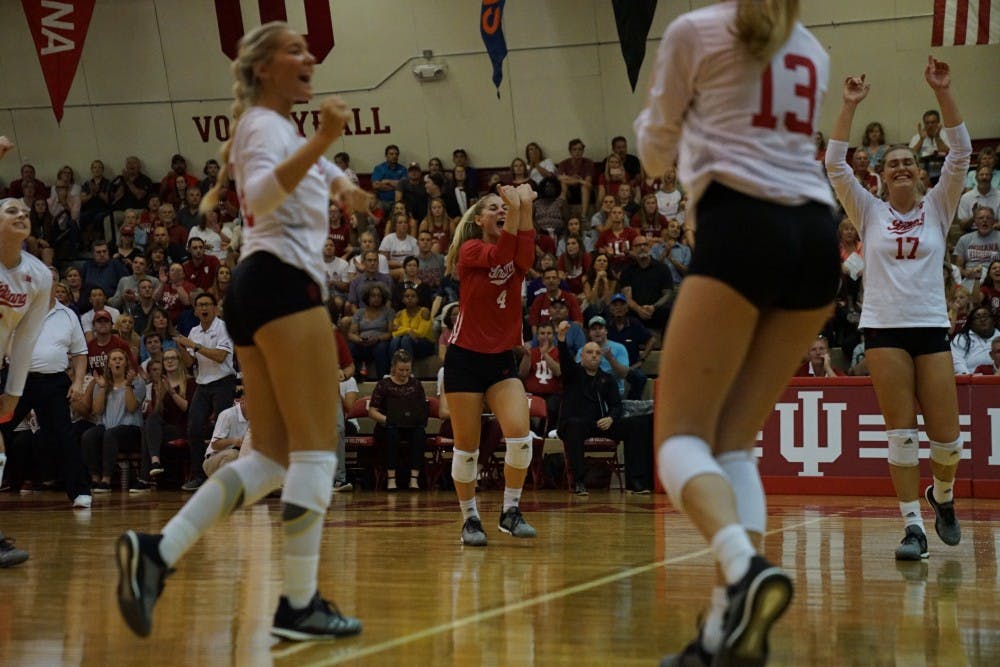 <p>Sophomore defensive specialist Bayli Lebo celebrates with her teammates after scoring a point during a long rally against Northwestern on Sept. 21 in the University Gym. Lebo leads the team in digs this season.</p>
