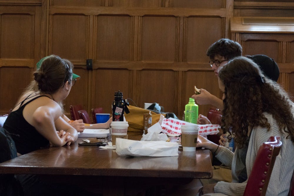 A group of students have lunch at the Collins dining hall on Tuesday.