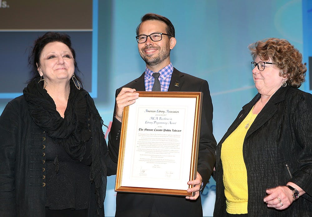 ALA President Julie Todaro (left) and Cultural Communites Chair Cassandra Barnet present Michael Hoerger of the Monroe County Public Library with the ALA Excellence in Library Programming Award on Sunday, June 25, in Chicago.