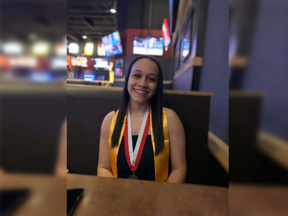 Then-high school senior Ana Allen poses for a picture wearing a medal for mainting academic excellence through her high school years on May, 28, 2021. Now an IU freshman, Ana Allen is a first generation African American student.