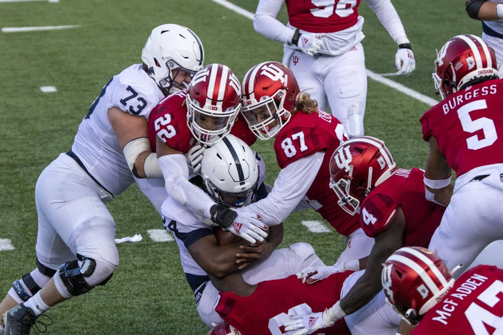 <p>Senior defensive lineman Michael Ziemba and junior defensive back Jamar Johnson tackle Penn State freshman running back Keyvone Lee on Oct. 24 in Memorial Stadium.﻿ IU football has paused all team-related activities due to an increase in COVID-19 cases, according to a press release.</p>