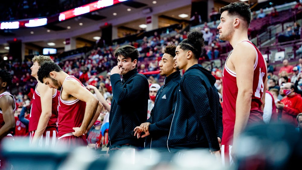 Guards Trey Galloway, Rob Phinisee  and Khristian Lander watch from the bench Feb. 21, 2022, at the Schottenstein Center. Indiana will face Maryland at 7 p.m. Feb. 24 at home. 