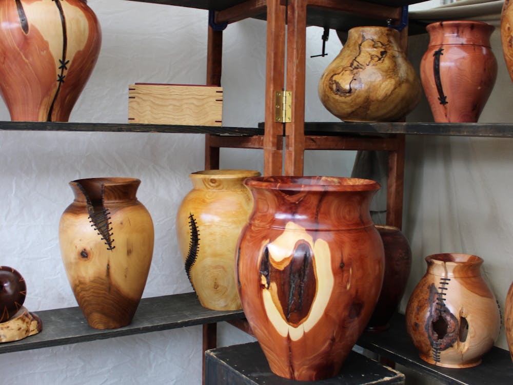 William Steffen&#x27;s woodworks were presented Sept. 3, 202,3 at Fourth Street Festival of the Arts and Crafts. He said making miniature dressers takes measurements, while making a vase is done by sight.