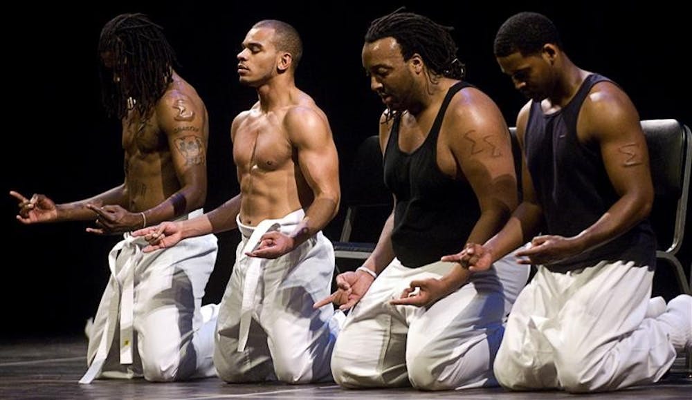 Members of the step dance group Indiana Revolution kneel during their kung fu-inspired performance in the 25th Annual Statewide Step Show Saturday evening at the IU Auditorium. Eight teams from around the state, including teams from every Phi Beta Sigma chapter in the state, competed for the top prize of $3,000.