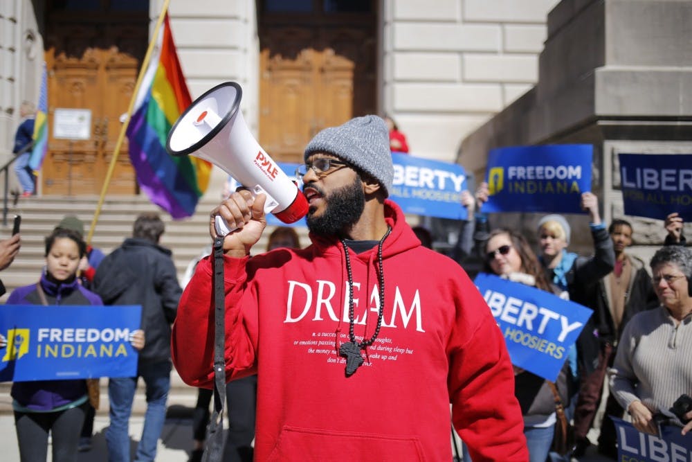 Dominic Dorsey leads a group of protestors in chants on the steps of the Indiana State Capitol Building "This is what democracy looks like," he screamed into the microphone.