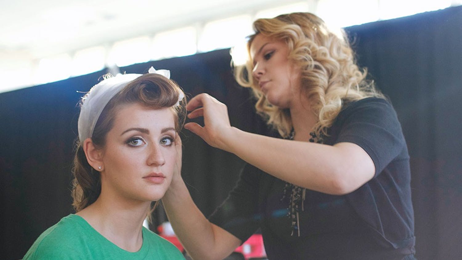 Amy Blake gets her hair done by a Paul Mitchell School Indianapolis hair stylist before walking in the Indiana University Fashion Show at the Indiana Memorial Union Alumni Hall. The fashion show was produced by Retail Studies Organization and showcased the designs of IU students earning a bachelors degree in Fashion Design.