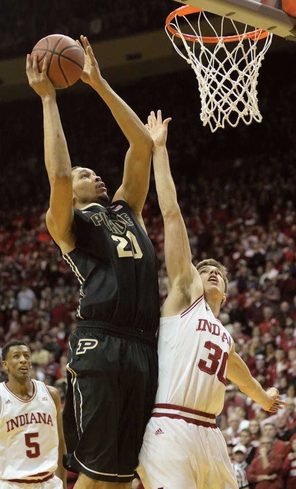 Sophomore forward Collin Hartman puts a hand up while Purdue center A.J. Hammons attempts a layup.