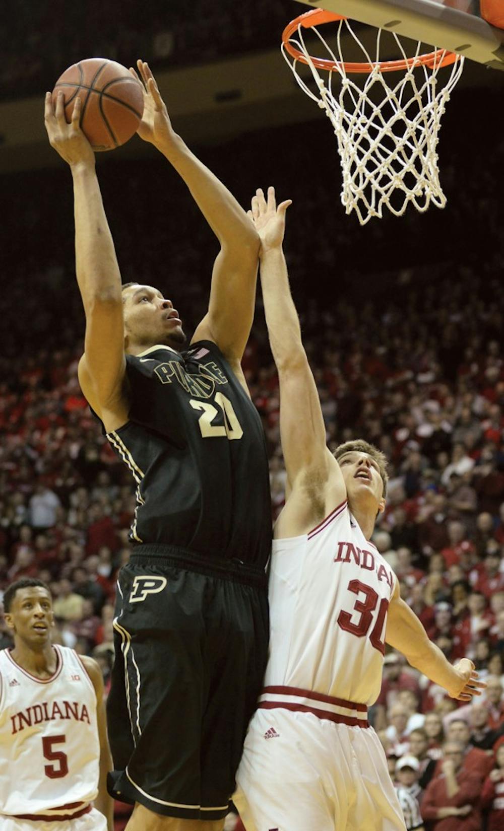Sophomore forward Collin Hartman puts a hand up while Purdue center A.J. Hammons attempts a layup.