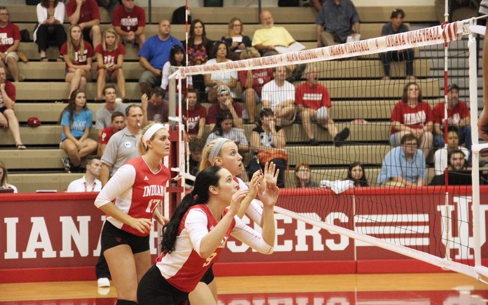 From left to right, Kendall Beerman, Hayden Huybers, and Megan Tallman get themselves ready for the incoming attack from the opponent, the Northwestern, on Wednesday.