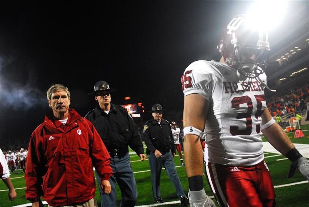 Senior IU defensive end Ryan Marando, right, walks off the field ahead of IU head coach Bill Lynch following IU's 55-13 loss to Illinois on Saturday in Champaign, Ill. In two straight games, the Hoosiers have allowed 103 points.