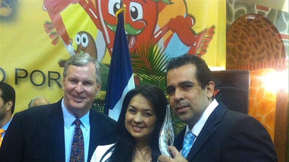 2014 Indiana Latino Educator of the Year recipient Israel F. Herrera stands with his wife Claudia Aparicio and Indianapolis Mayor Gregory Ballard on May 3, 2014 at the Indiana Latino Expo in Indianapolis, Ind.