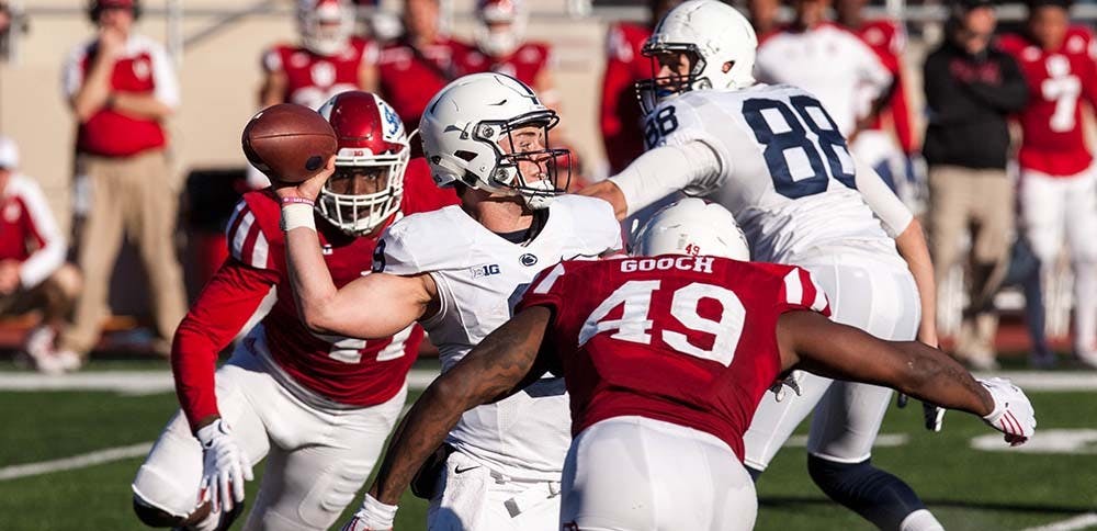 Junior defensive lineman Greg Gooch tackles sophomore quarterback Trace McSorley during the second half of play Saturday at Memorial Stadium
