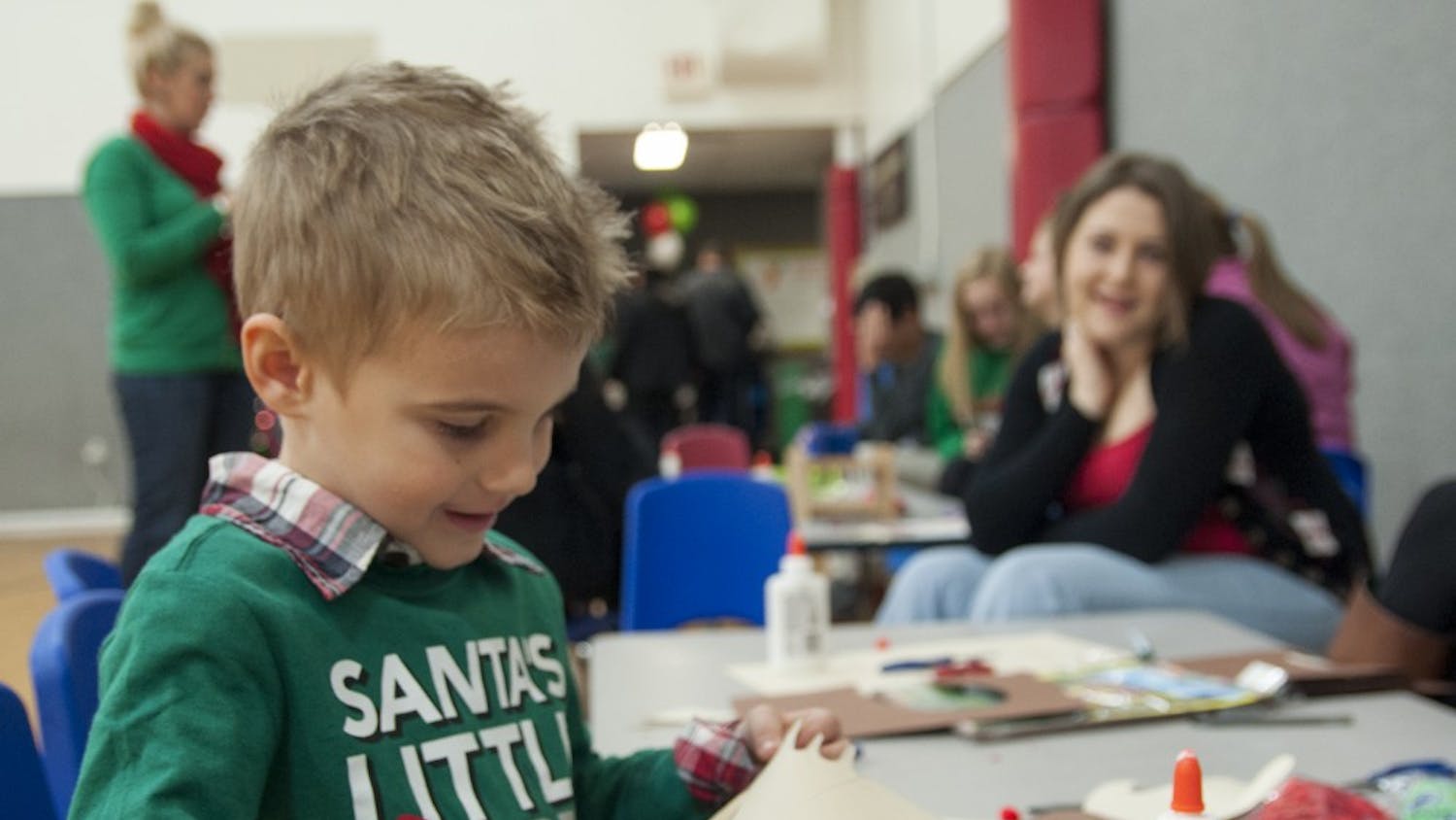 Four-year-old Parker Foust cuts paper to make a reindeer craft during Breakfast with Santa in 2013 at the YMCA. The YMCA had to shut down their childcare program because they could no longer afford the financial subsidies required to remain a licensed child care center.
