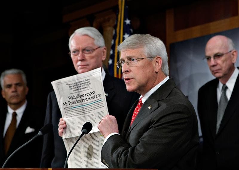 Sen. Roger Wicker of Mississippi joins other Senate Republicans in opposition to President Barack Obama's financial stimulus package as he displays a newspaper advocacy ad during a news conference at the Capitol Thursday in Washington.