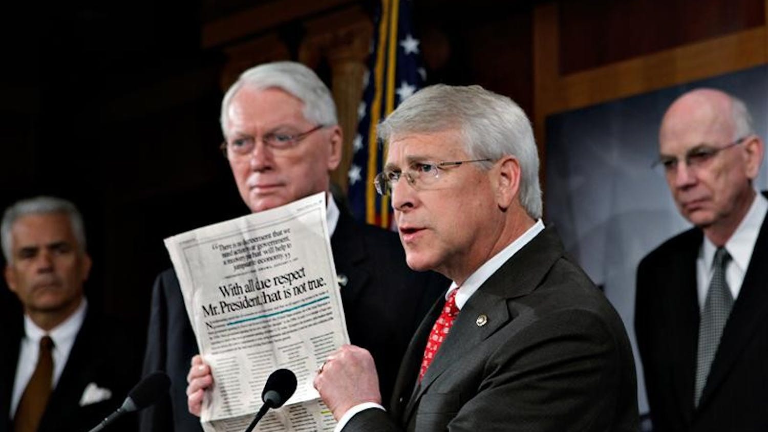 Sen. Roger Wicker of Mississippi joins other Senate Republicans in opposition to President Barack Obama's financial stimulus package as he displays a newspaper advocacy ad during a news conference at the Capitol Thursday in Washington.