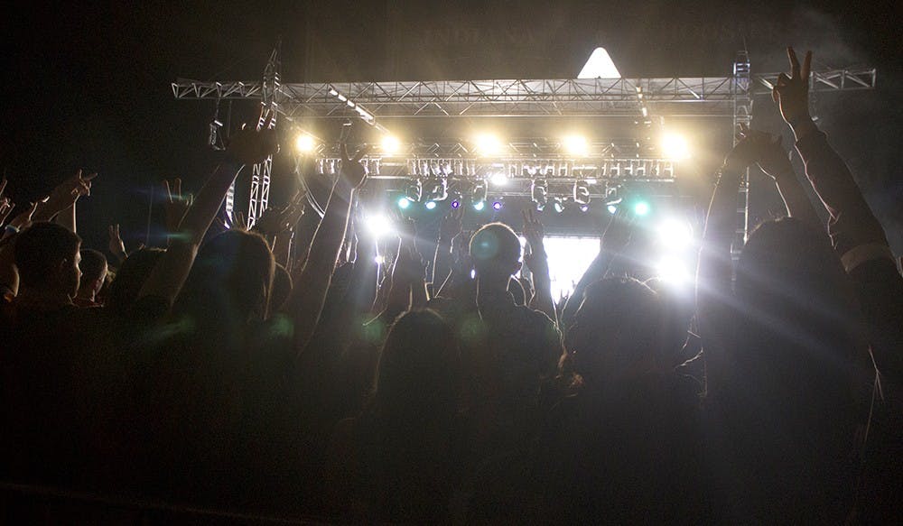 During the Flosstradamus concert Friday at Memorial Stadium, the audience enjoys one of the duo's last songs. Two fingers are put up through out the audience to symbolize the peace that they want to see in the world.
