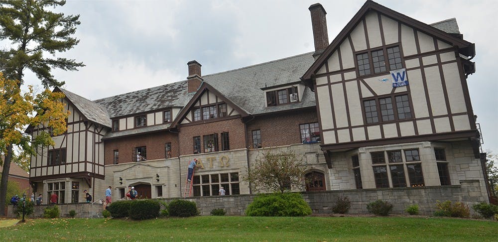 The letters of the Alpha Tau Omega fraternity house are taken down Thursday afternoon after the chapter was revoked by the fraternity's national office. ATO and select individuals were accused of hazing, endangering a student, possessing and consuming alcohol and lying to University officials.