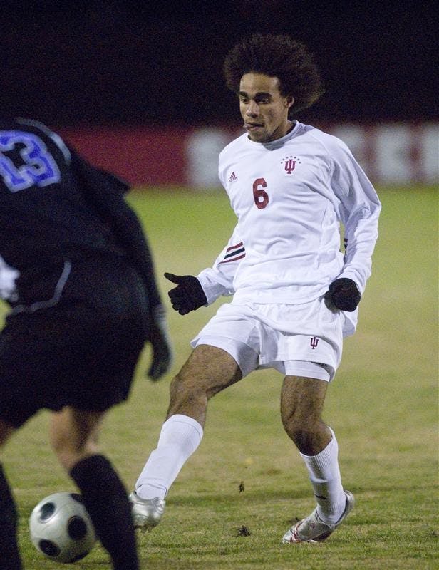 Junior midfielder Kevin Alston passes the ball off past a Northwestern defender Friday night at Bill Armstrong Stadium. The Hoosiers defeated the Wildcats 2-0.