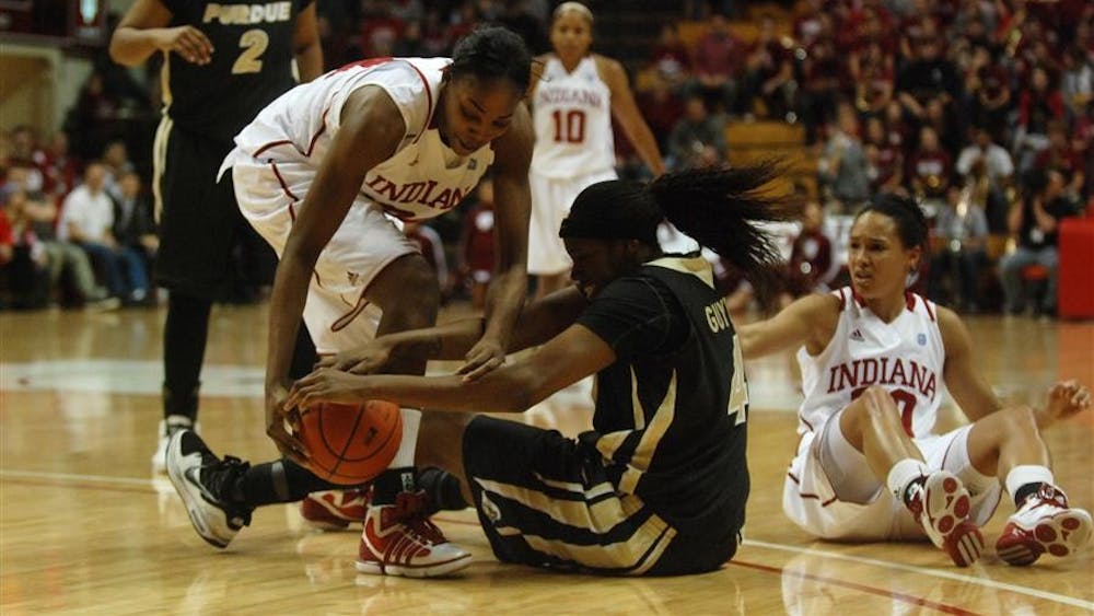 Junior forward Georgie Jones fights with Purdue's Alex Guyton for a loose ball during IU's 55-50 loss to the Boilermakers on Sunday at Assembly Hall. The loss brings the Hoosiers to 8-8 on the season and 1-3 in the Big Ten.
