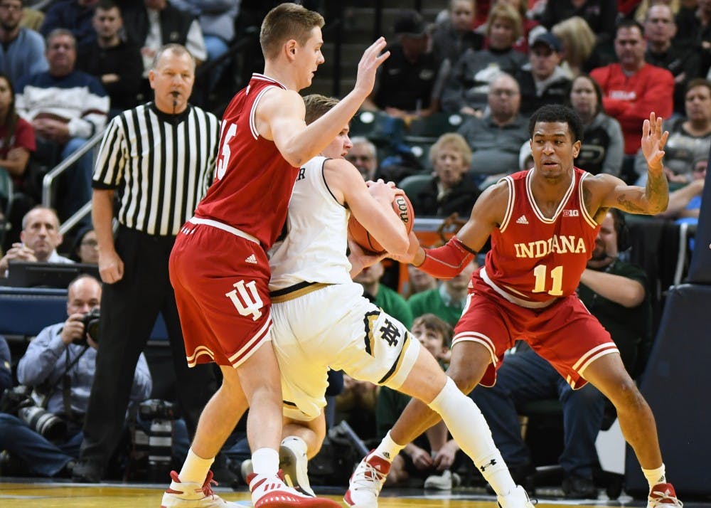 Junior guard Zach McRoberts and sophomore guard Devonte Green defend against Notre Dame's Rex Pflueger on Saturday afternoon in Bankers Life Fieldhouse. IU defeated Notre Dame in overtime, 80-77.