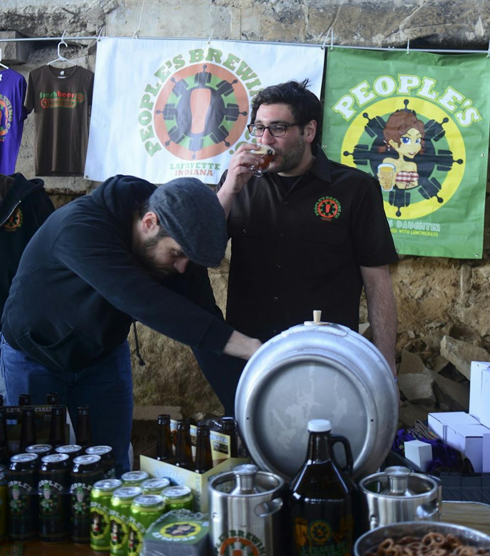 Phill Green takes a sip of the Imperial Pilsner while setting up the People’s Brewing Company’s booth at the 5th Annual Bloomington Craft Beer Festival on Saturday early afternoon. 