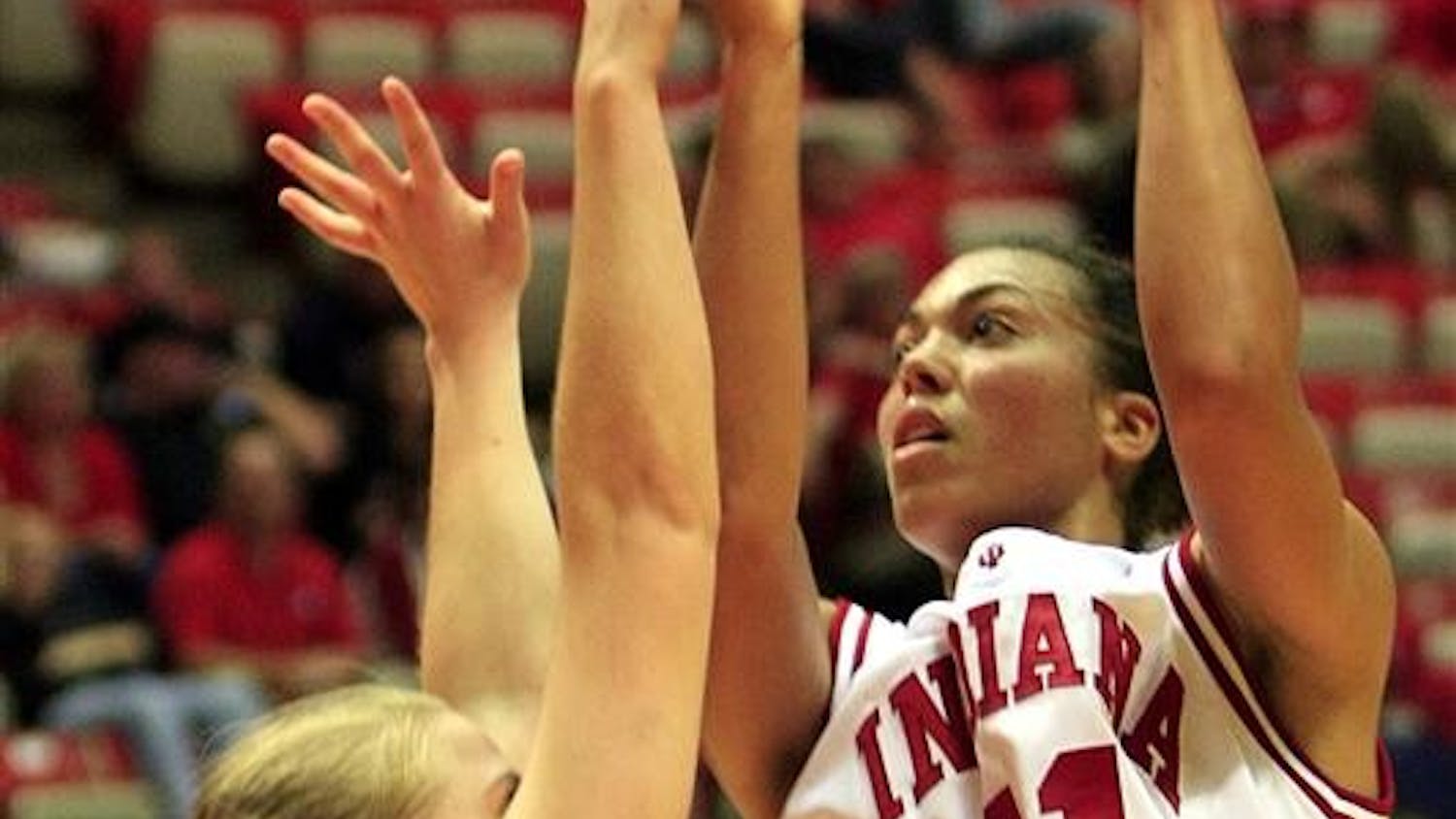 IU senior forward Whitney Thomas goes up for a basket over Southern Indiana's Courtney Perry during a game on Saturday at Assembly Hall. IU won 93-49.