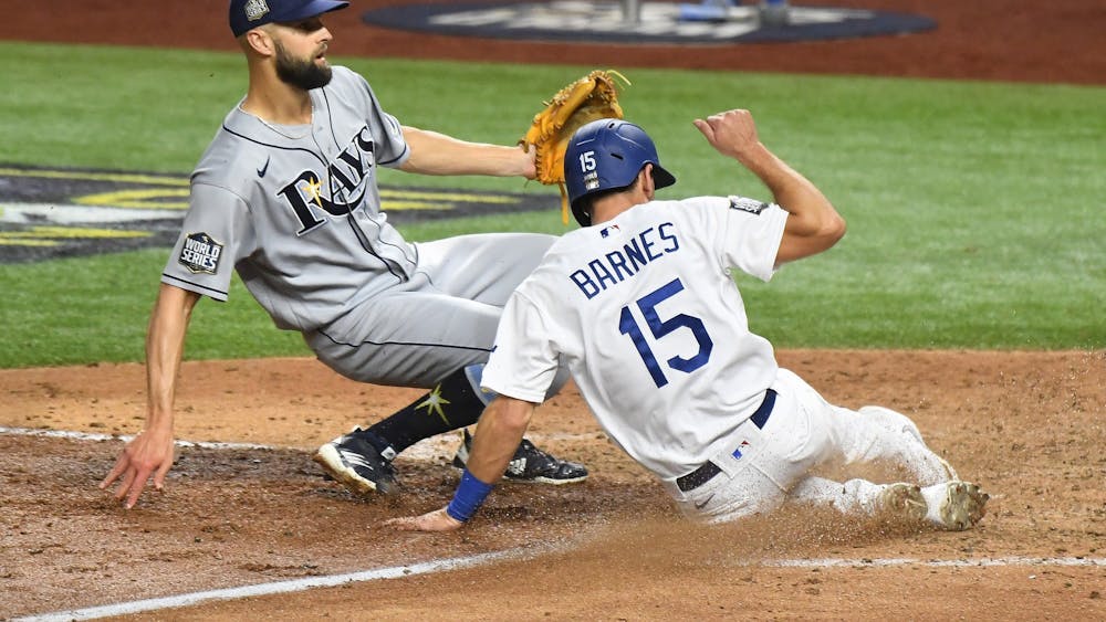The Los Angeles Dodgers Austin Barnes scores in front of Tampa Bay Rays pitcher Nick Anderson on a wild pitch in the sixth inning during Game 6 of the World Series, on  Oct. 27 at Globe Life Field in Arlington, Texas.