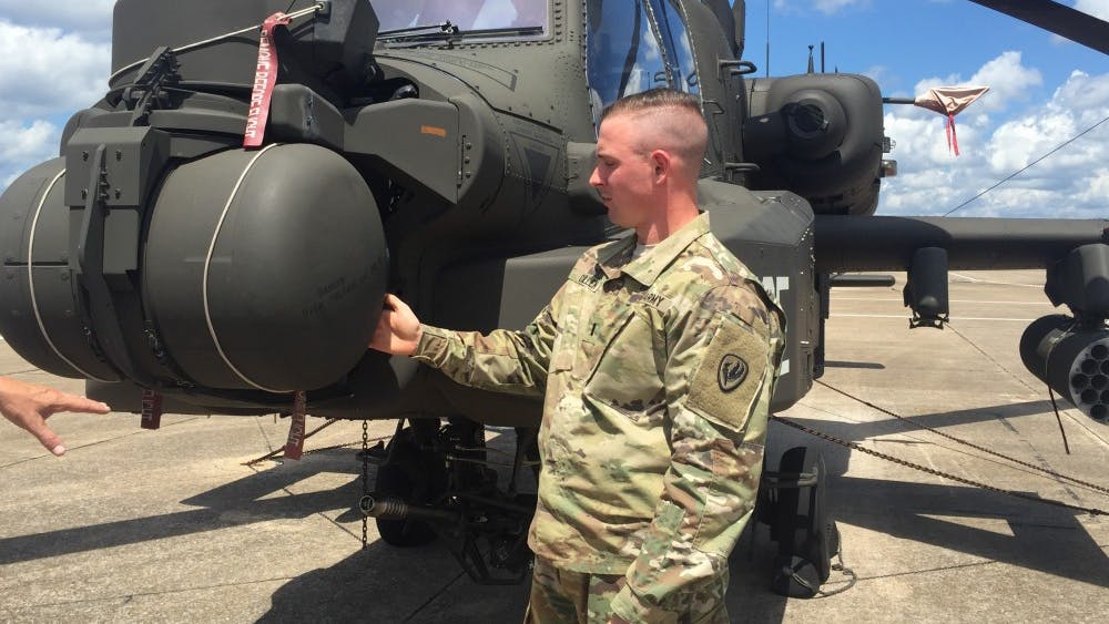 1st Lt. Clayton Cullen stands next to his AH64 Apache helicopter at Fort Rucker, Alabama Aug. 16, 2017. Cullen died in a helicopter crash during training operations at the National Training Center at Fort Irwin, California.
