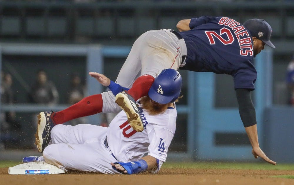 <p>The Los Angeles Dodgers' Justin Turner is out at second in a failed bid to break up a double play as Boston Red Sox shortstop Xander Boegaerts tumbles over him Oct. 26, 2018 during Game 3 of the World Series at Dodger Stadium in Los Angeles.</p>