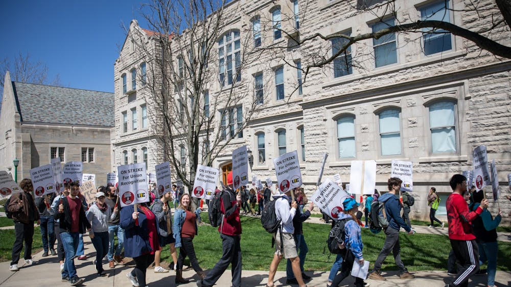 Strikers protest in support of the graduate student union on April 14, 2022, at Swain Hall. The Indiana Graduate Workers Coalition - United Electrical Workers are a multidisciplinary group of graduate workers fighting for better working conditions for graduate student workers at IU-Bloomington, according to the IGWC-UE website.