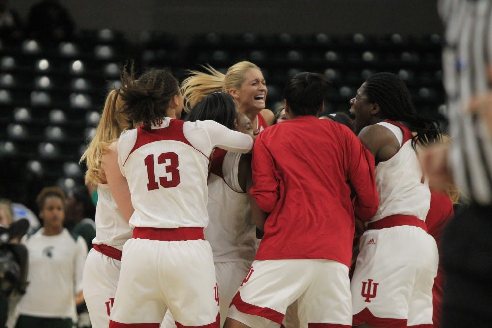 <p>The IU women's basketball team huddles and cheers after winning against Michigan State in a historic game. IU's first Big Ten Tournament game broke two records by being the longest game and scoring the most points, 111, in tournament history.</p>