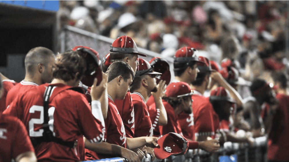 The Hoosiers remove their rally caps in the dugout after losing to the Golden Gophers 9-8 Friday evening. IU earned a two seed in the Lexington regional for the NCAA tournament.
