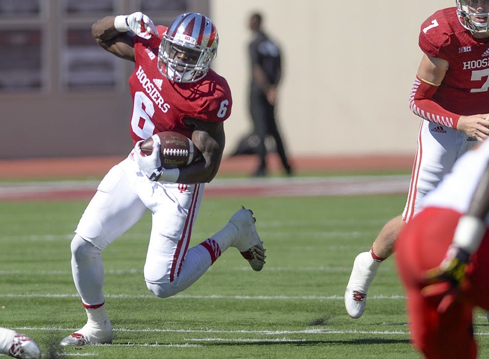 Then-junior running back Tevin Coleman runs with the ball during IU's game against Maryland on Sept. 27, 2014, at Memorial Stadium. Coleman was one of six former IU players who played in NFL games during week four.