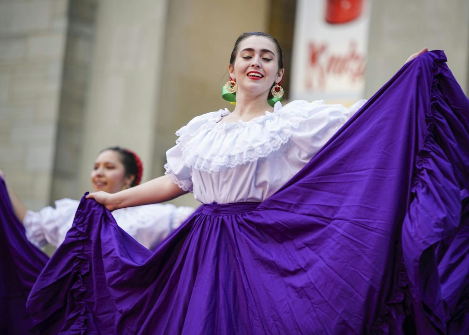 Third-year graduate student Patty Gonzalez of Ballet Folklorico performs as the group begins to draw a crowd during the Hispanic Heritage Month-themed First Thursday festival in the Fine Arts Plaza. Inclement weather forced acts such as the IU Soul Revue and IU Contemporary Dance to take their performances to Neal-Marshall Grand Hall and the School of Public Health.
