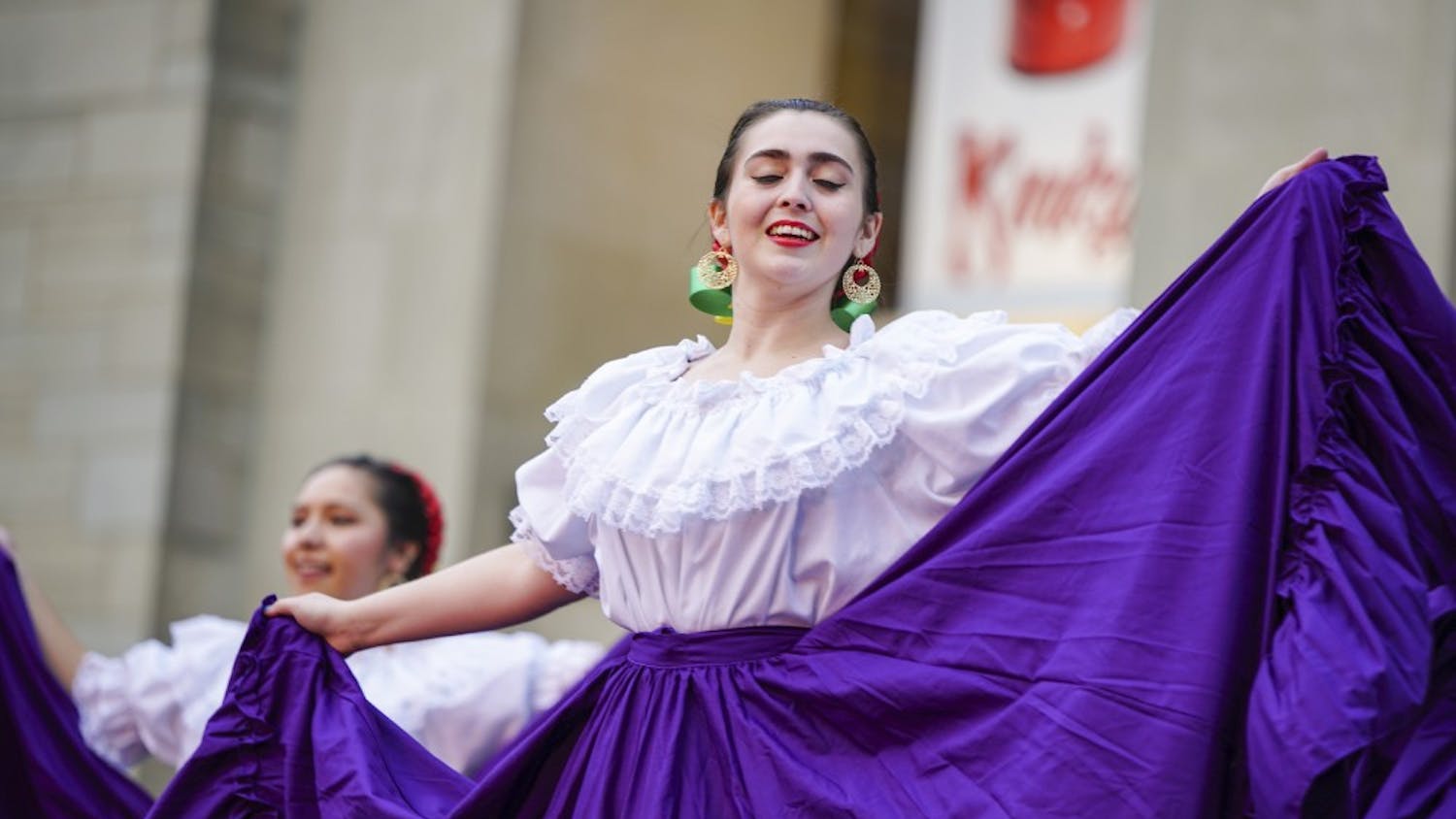 Third-year graduate student Patty Gonzalez of Ballet Folklorico performs as the group begins to draw a crowd during the Hispanic Heritage Month-themed First Thursday festival in the Fine Arts Plaza. Inclement weather forced acts such as the IU Soul Revue and IU Contemporary Dance to take their performances to Neal-Marshall Grand Hall and the School of Public Health.
