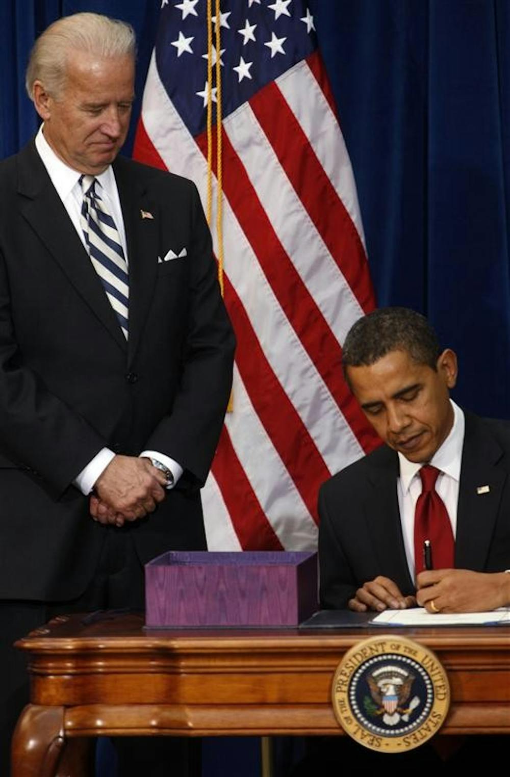 With Vice President Joe Biden looking on, President Barack Obama signs the economic stimulus bill during a ceremony on Tuesday in the Museum of Nature and Science in Denver.