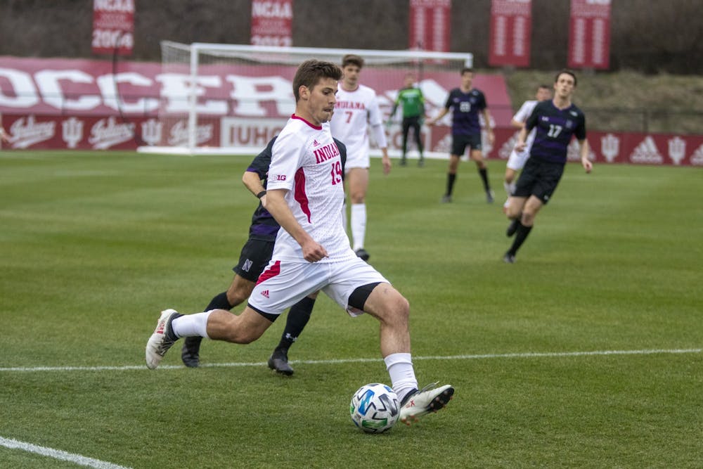 Then-sophomore defender Brett Bebej passes the ball March 23, 2021 in Bill Armstrong Stadium. Bebej scored a goal in the 85th minute of Indiana's 3-0 win against Ohio State on Tuesday night. 