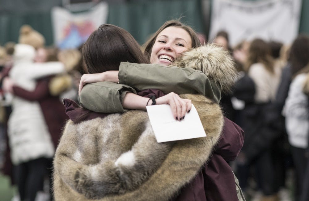 Taylor Rosenberg hugs Hanna Bloom after receiving a bid at the IU Tennis Center in 2018. The women received their bids together and left with their houses on buses.&nbsp;