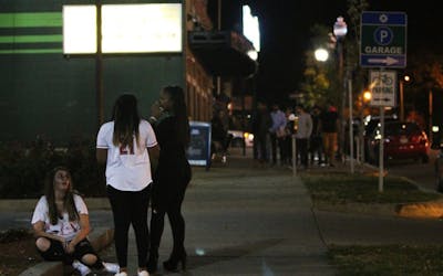 Three girls dressed up in costume take a breather outside Taco Bell next to Kilroy's Sports Bar, which had partially closed for the night in 2016. Halloween weekend in Bloomington, Indiana, means many students from IU dress up and go out to parties or to the bars.
