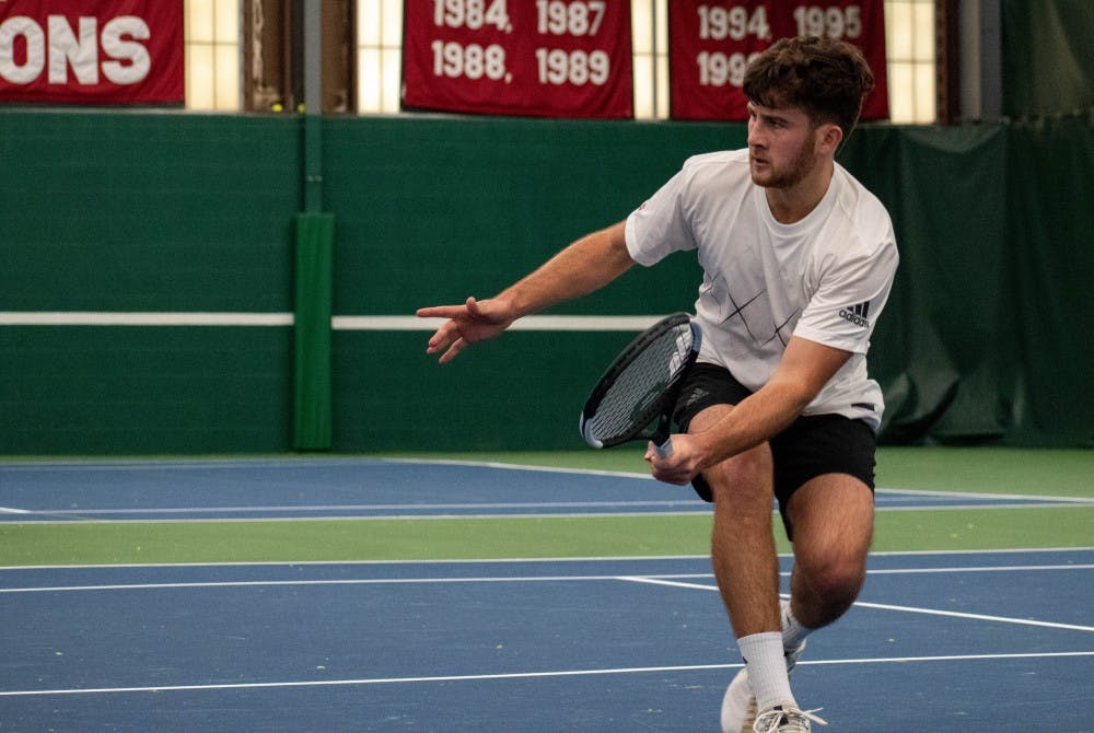 <p>Junior Zac Brodney reaches for a volley Jan. 13 at the IU Tennis Center. He won at No. 5 singles 6-1, 3-6, 7-5 against Ball State University sophomore Chris Adams.</p>