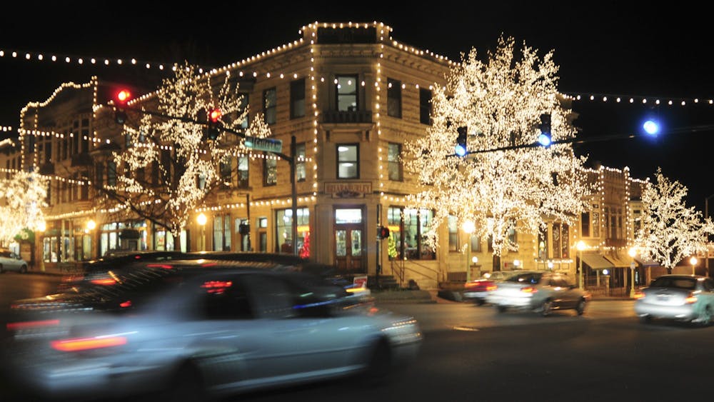 Cars drive under the Canopy of Lights in downtown Bloomington.