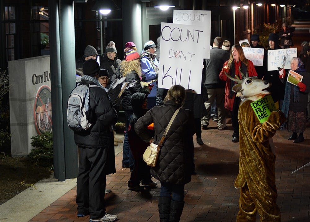 Local residents protest against the killing of deer in Bloomington on Thursday outside of Bloomington City Hall.