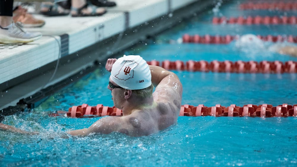 Senior Michael Draves celebrates his win in the men&#x27;s 100-yard free race on Jan. 28, 2022. He was able to take first place followed by three Evansville swimmers. 