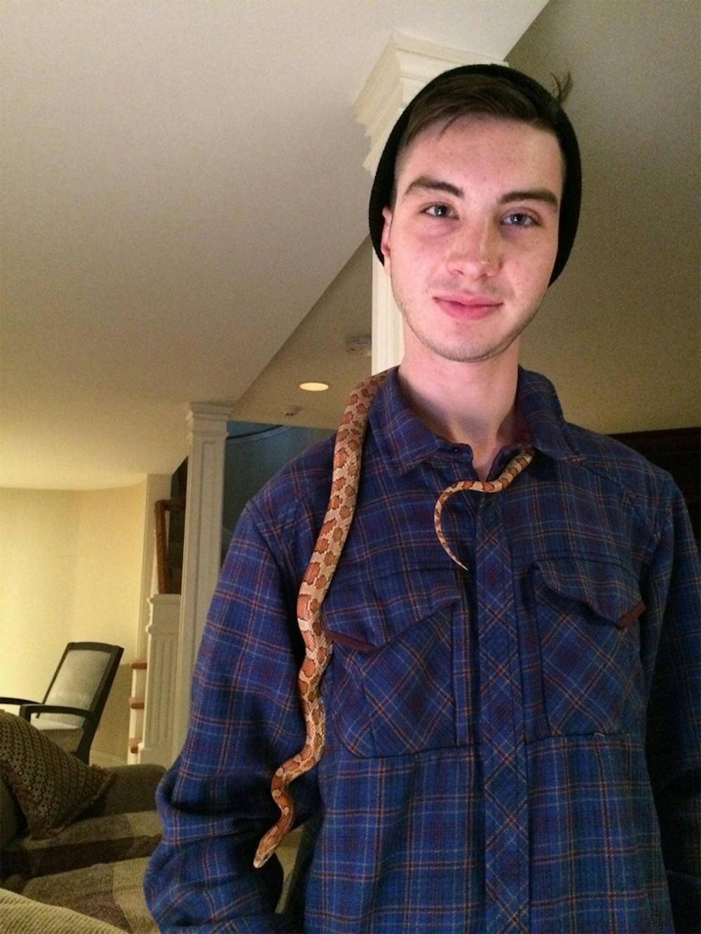 Aaron Holme with his corn snake Gatsby. Holme died March 4 in Bloomington. 