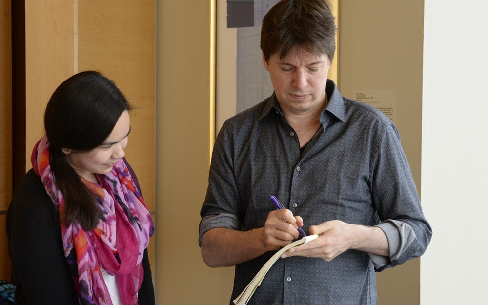 Violinist Joshua Bell signs autographs with students after a round-table discussion. The discussion was open only to Jacobs students, who were able to eat lunch and ask the musician questions.