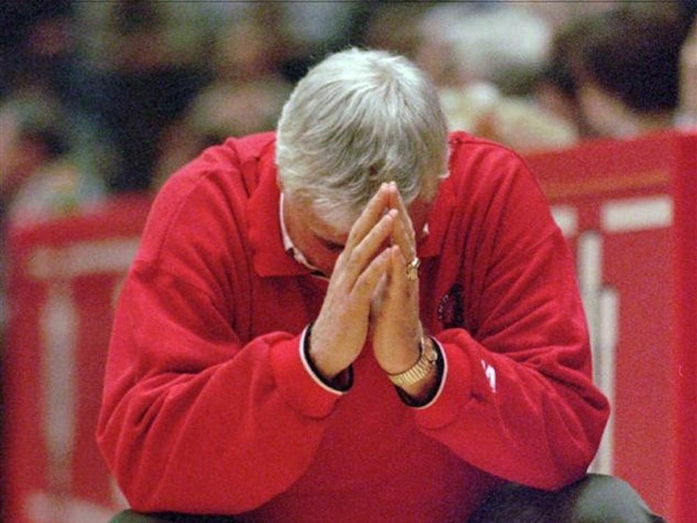 Indiana coach Bobby Knight crouches down in frustration as his team relinquishes their lead in the final minutes against Illinois in a 1997 game at Assembly Hall. 