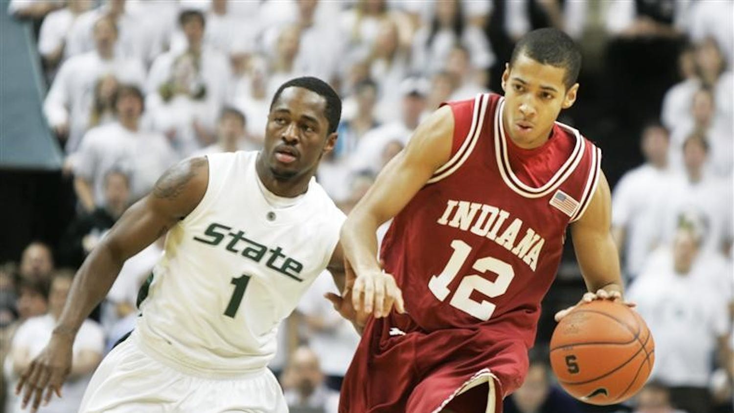 IU freshman guard Verdell Jones dribbles as Michigan State sophomore guard Kalin Lucas chases after him Saturday evening at Michigan State University. 